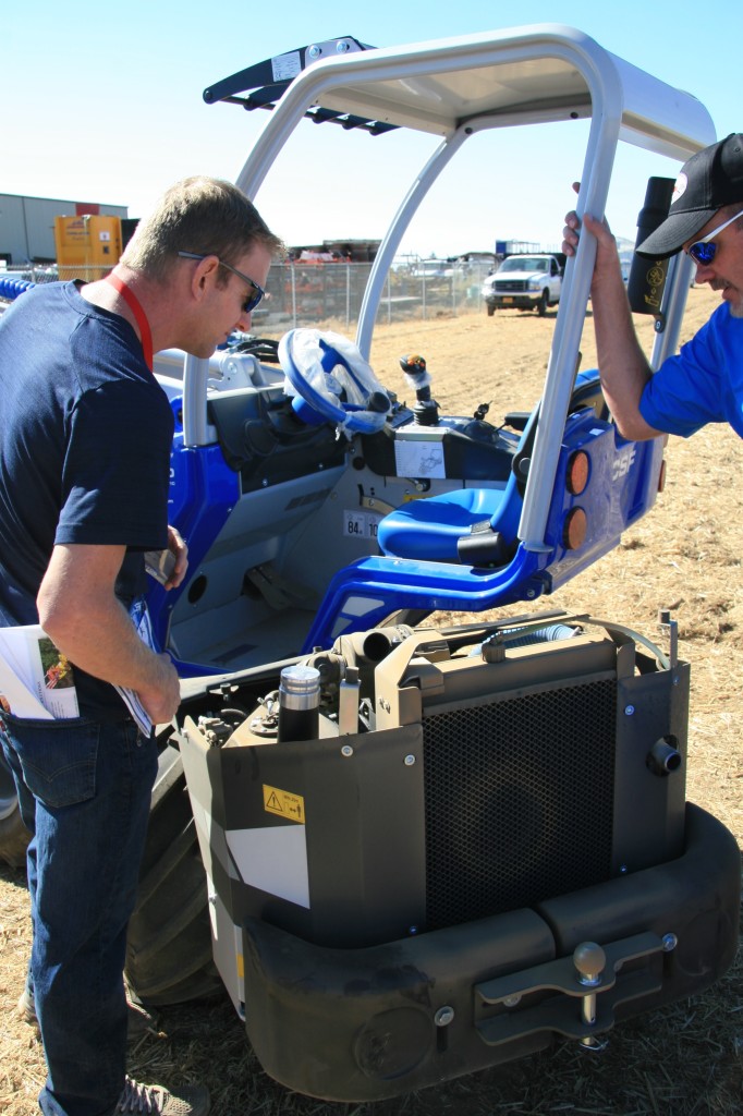 Jim Simnitt of Simnitt Nursery inspects the engine of the Multione GT 950, one of two pint-sized but powerful skidders demonstrated at the event. 