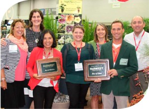 Frailest Show chair Ryan Basile presents the award for best booth to the staff members at Skagit Gardens. Photo by Curt Kipp